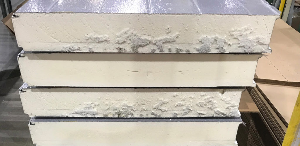A close-up cross-section picture of four foam-filled garage door panels stacked one atop the other.