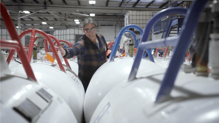 Worker tags supply tanks of Iso and Polyol for shipping to OEM customers