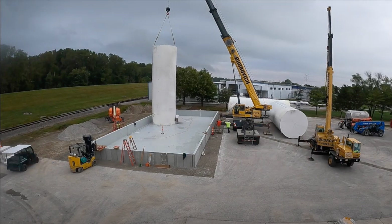 Construction crews using cranes to lift and set supply Storage tanks at FSI to increase capacity